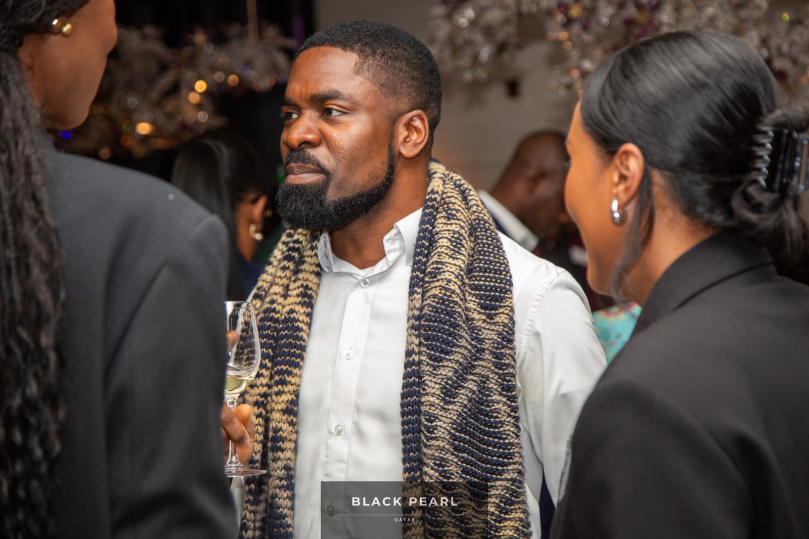 Three members in elegant conversation at a Black Pearl evening