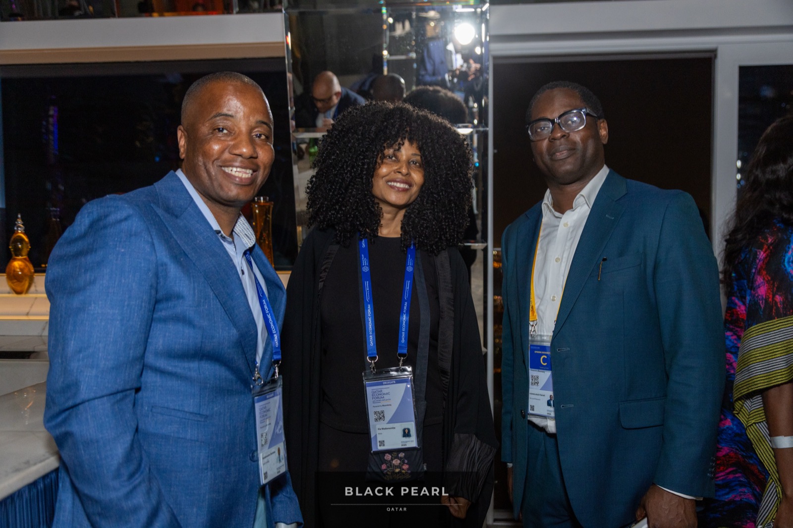 Three guests smiling together at a Black Pearl evening
