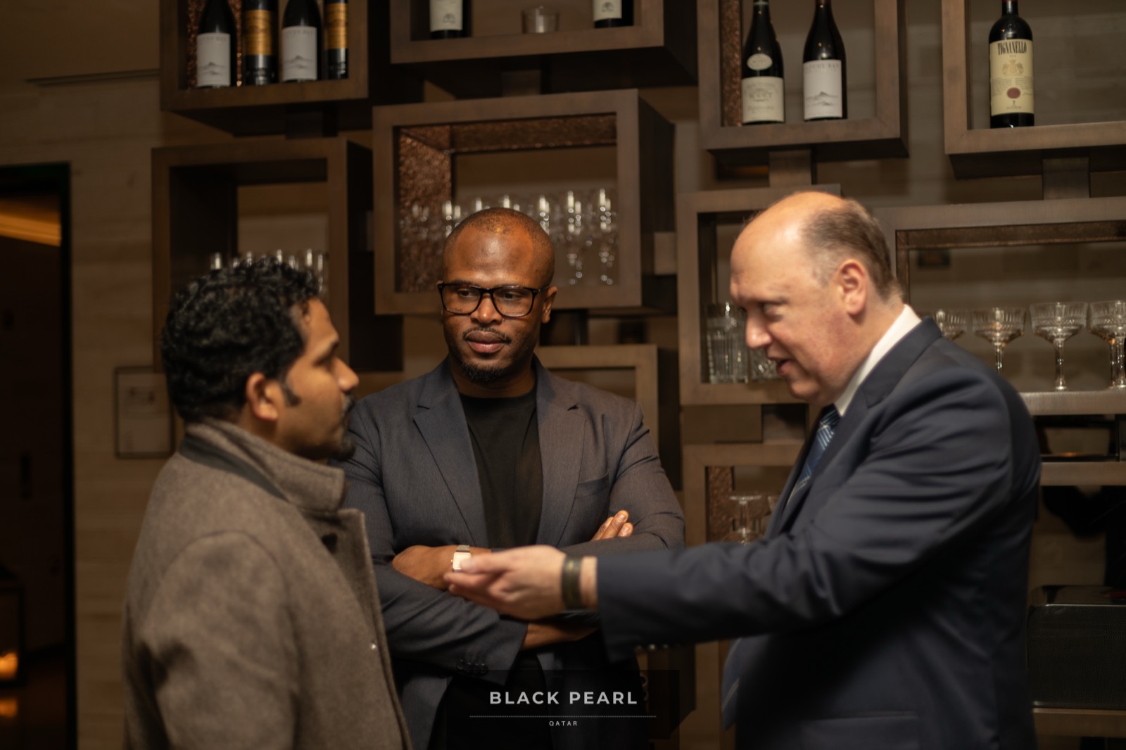 Three members in conversation at an upscale Black Pearl evening